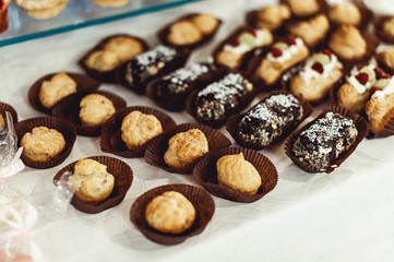 eclairs, traditional french dessert. white table