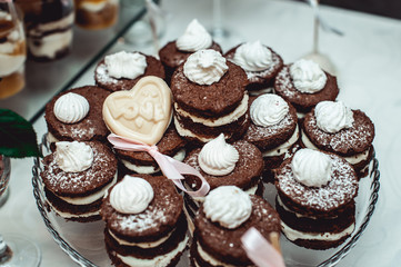 Sandwich cookies of brown color. Lots of biscuits with custard. Pastry with vanilla filling.