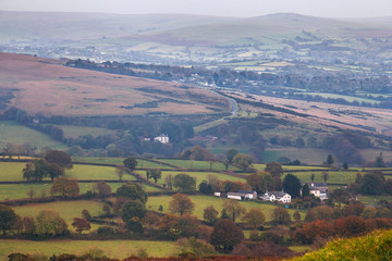 The village and farmlands in the Dartmoor National Park. Evening and haze. Autumn. Devon. England