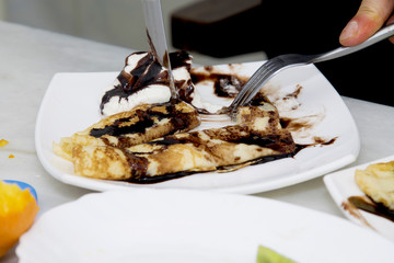 eating crepes and pancakes in the foreground