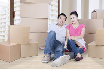Romantic couple sitting with boxes