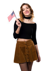 Beautiful young girl holding an american flag