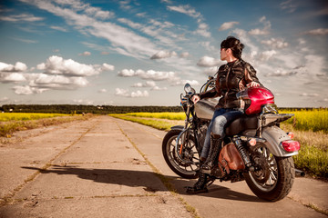 Obraz na płótnie Canvas Biker girl on a motorcycle