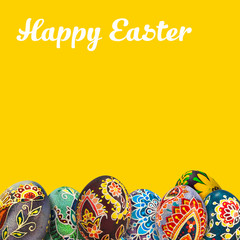 Easter eggs over yellow background. View with copy space