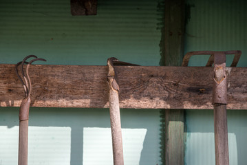 garden tools hanging on wooden board
