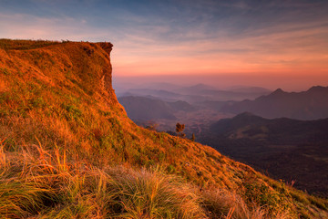 Sunset scene with the peak of mountain and cloudscape at Phu chi fa in Chiang rai, Thailand