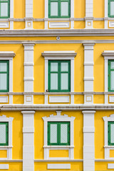 Fototapeta na wymiar green window on yellow wall