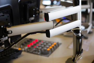 Microphone and monitor carrier in radio studio