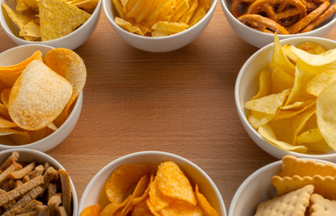 Pretzels in bowls on wooden table from above