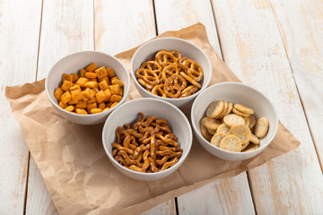 Pretzels in bowls on wooden table from above