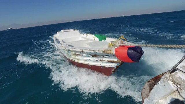 Little wooden boat attached for ship in the Red sea, Egypt