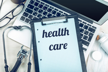 Stethoscope on laptop, close-up