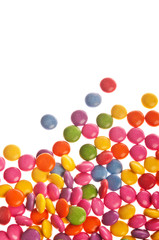 many colorful sugar coated candy, candies over white background 
