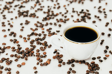 white coffee Cup and coffee beans on white background.