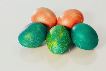 Red and green Easter eggs on white background.