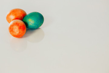 Red and green Easter eggs on white background.