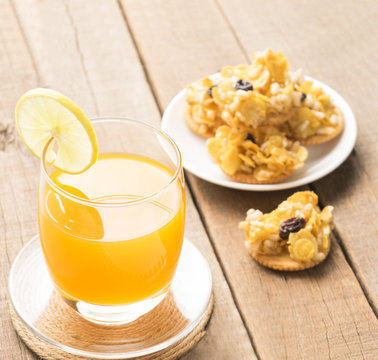 Orange juice and cereals,cracker,snack on table wood background