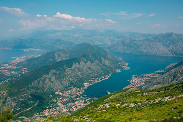 Naklejka na ściany i meble Bay of Kotor from the heights. View from Mount Lovcen to the bay. View down from the observation platform on the mountain Lovcen. Mountains and bay in Montenegro. The liner near the old town of Kotor.