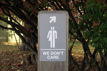Gender neutral restroom sign that says, WE DON'T CARE