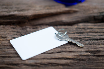 House key and keycard on wooden floorboards
