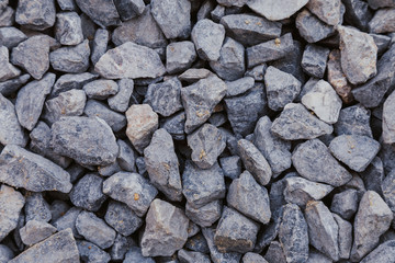 close up of crushed rock, stone raw material for construction industry. background and texture.