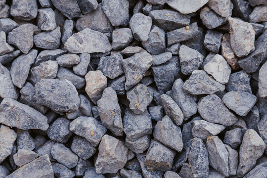 close up of crushed rock, stone raw material for construction industry. background and texture.