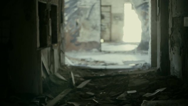 Gimbal steadicam pov shot of someone exploring the corridors and rooms of a huge demolished abandoned building.