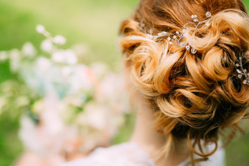 Hairstyle of the bride close-up. The hairdresser finished making a hairstyle.