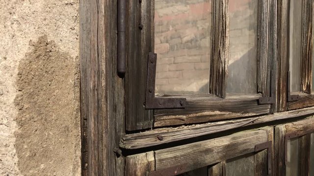 Broken glass and wooden openings of destructed building 4K 2160p 30fps UltraHD footage - Old house weathered window and walls 3840X2160 UHD video