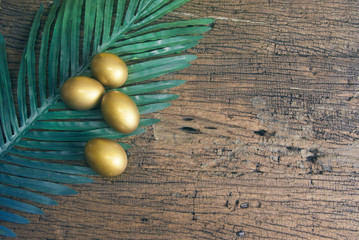 gold eggs with palm leaf