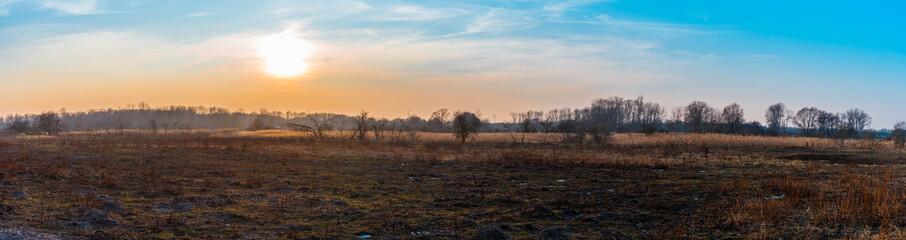 Fototapeta na wymiar Winter panorama of sunset over a dried landscape