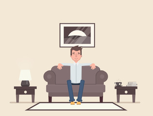 The man is sitting in the room and resting.