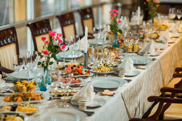 Festively decorated beautiful big table full of food ready for guests. Horizontal color photography.