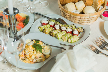 Festively decorated beautiful table full of food ready for guests. Horizontal color photography.