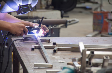 Soft focused picture of Worker is holding welding machine ,He is welding stainless steel pipe with  argon  mig - mag method in Industrial