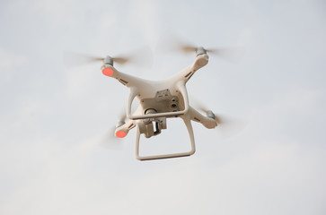 White Flying drone with stabilizer camera on the sky