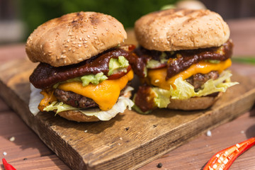 Close up grilled burgers on cutting board