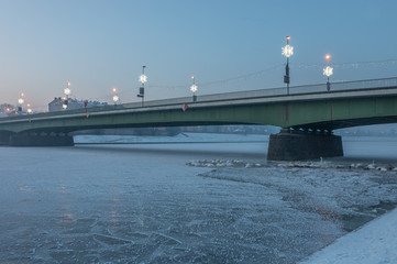 Debnicki bridge over frozen Vistula river in Krakow, Poland in the night