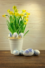 Hand painted eggs and narcissus in metal basket
