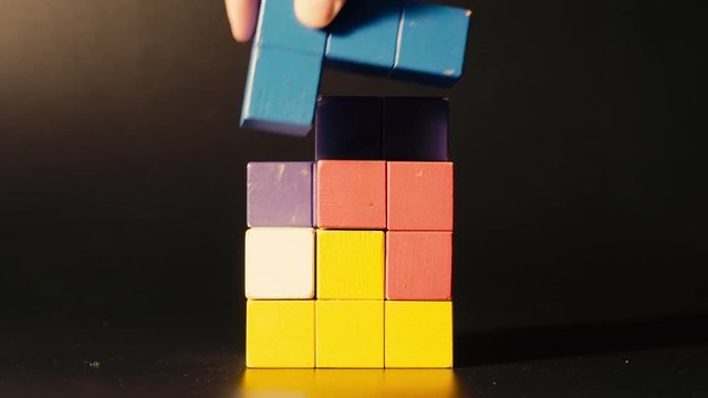 Man's hand picking 3D tetris