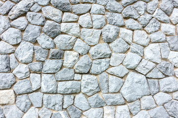 Background wall made of stones held together with cement. Wall made of stones close-up