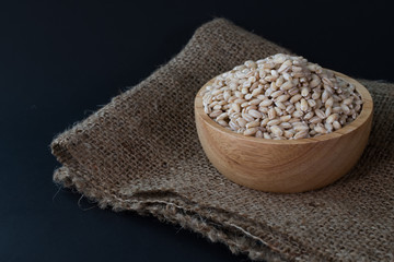 pearls barley grain seed on background.