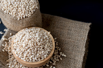 pearls barley grain seed on background.