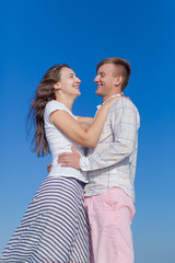 Portrait of attractive laughing couple on open air