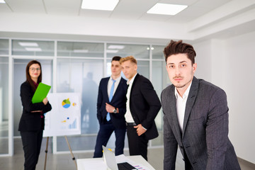 Businessman  looking stand on  background of business team the office.