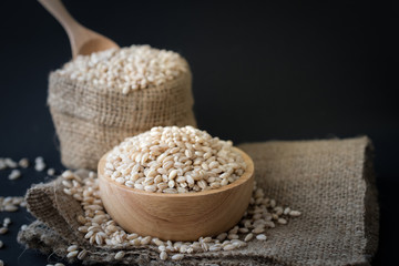 pearls barley grain seed on background.