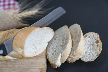 Freshly baked delicious bread on a rustic wooden background with copy space, flat lay..