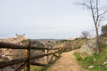 A path over the hill vith a view to Toledo Alcazar, evening at surroundings of Toledo, Castilla la Mancha, Spain.