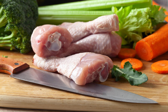 raw vegetables with chicken drumsticks