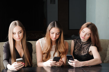 Young caucasian women using phone and saying no to life. Smartphone addiction concept